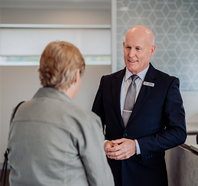 Gatton funeral director greeting woman