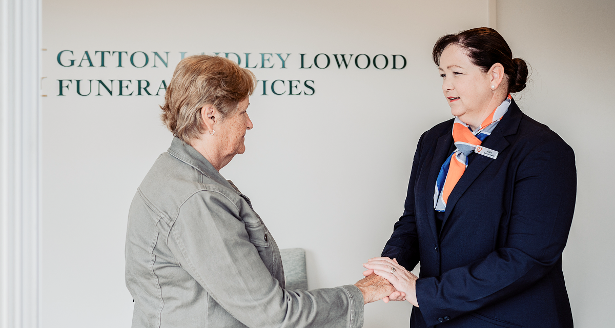 Gatton funeral director greeting a woman