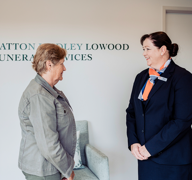 Gatton funeral director greeting woman