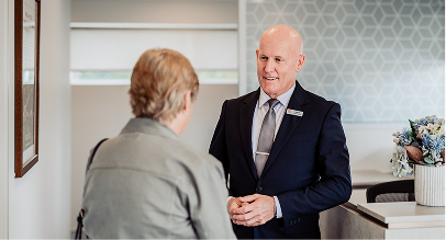 Gatton funeral director greeting a woman