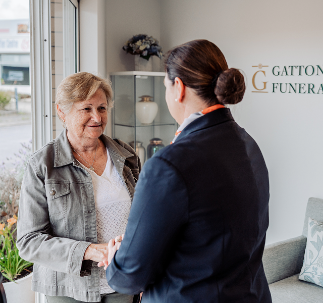 Gatton funeral director greeting woman