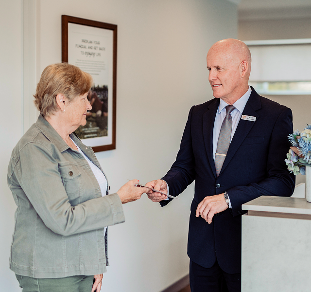 Gatton funeral director greeting woman