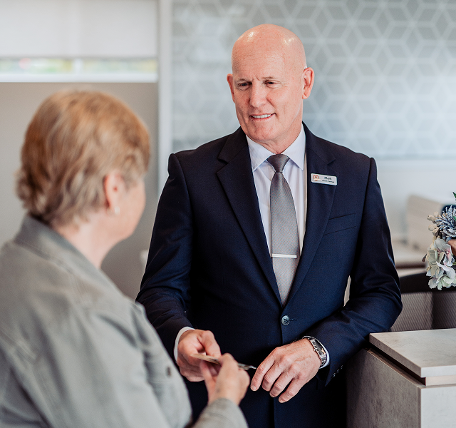 Gatton funeral director greeting woman