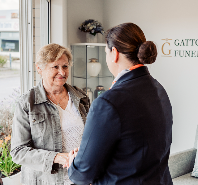 Gatton funeral director greeting woman