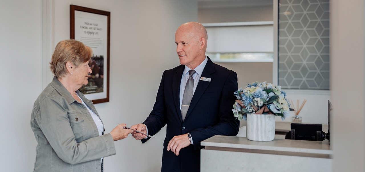 Gatton funeral director greeting a woman
