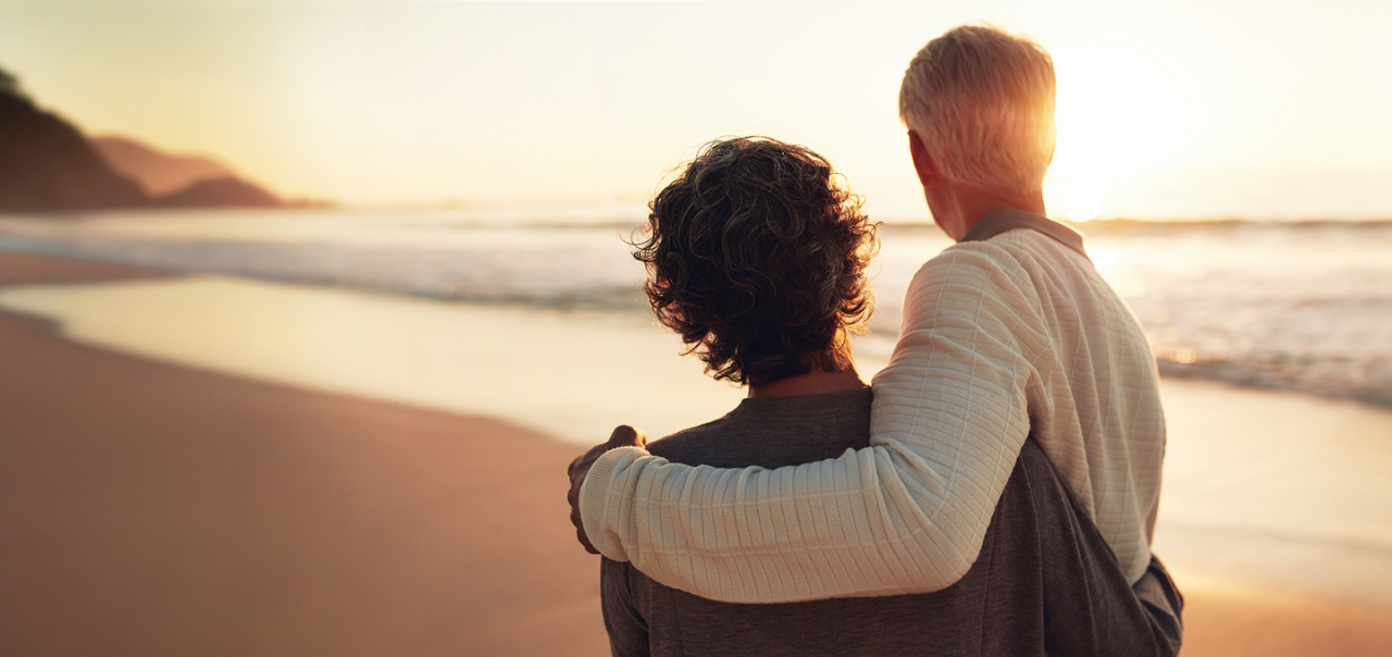a man and woman looking at sunset