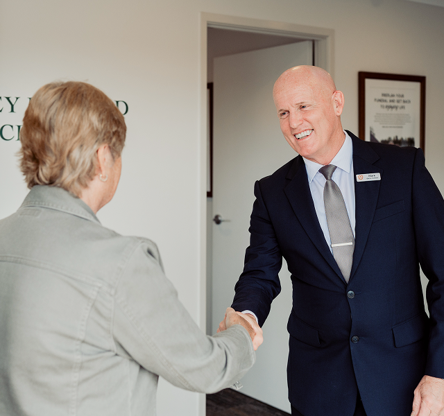 Gatton funeral director greeting woman