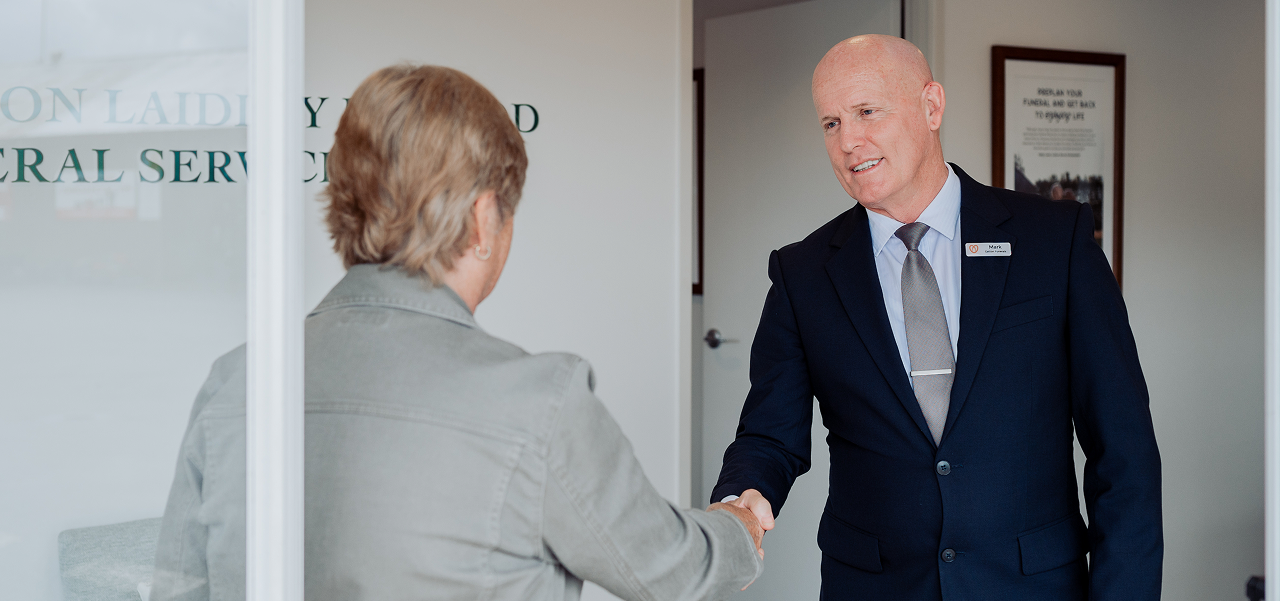 Gatton funeral director greeting a woman