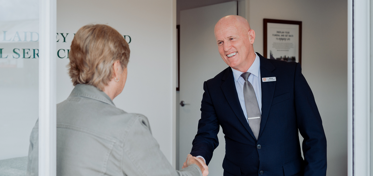Gatton funeral director greeting a woman